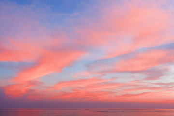 View of the blue-pink sky with clouds at sunset in the background of the sea. Beautiful natural layout