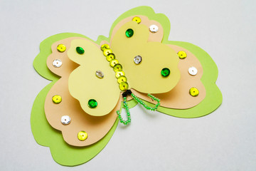 Application made with hot melt glue gun. Yellow green butterfly made of colored paper,...