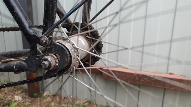 The Wheel spinning on an old bike. The wheel is spinning.