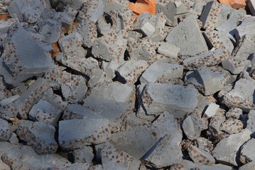 gray texture of pieces of concrete and stones in a pile of garbage