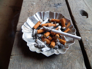 cigarette in an ashtray.Butts in the ashtray.
