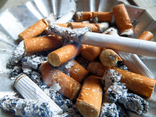 cigarettes in ashtray.Butts in the ashtray.