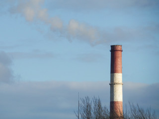 Smoke from the chimney against the blue sky.