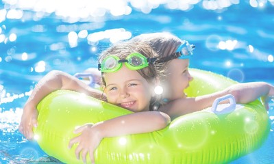 Children playing in pool. Two little girls having fun in the pool. Summer holidays and vacation concept