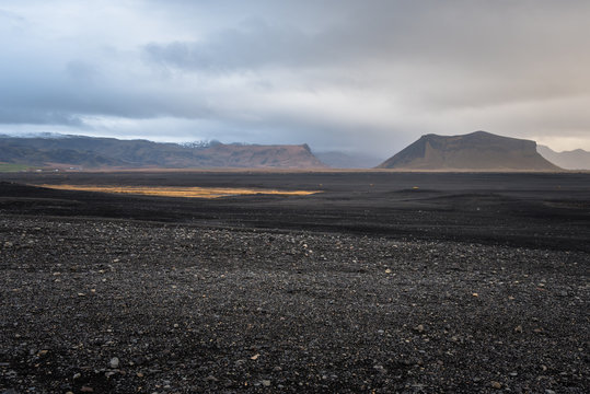Deserted Volcanic Landscape with Mountains in Background in Iceland on a Cloudy Fall Day