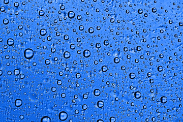 fresh drops background blue glass / wet rainy background, water drops transparent glass blue