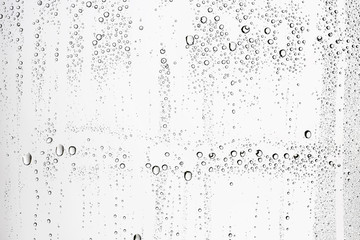 white isolated background water drops on the glass / wet window glass with splashes and drops of water and lime, texture autumn background