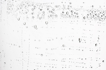 white isolated background water drops on the glass / wet window glass with splashes and drops of water and lime, texture autumn background
