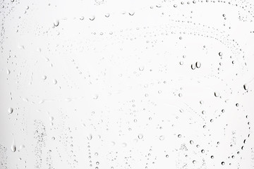 white isolated background water drops on the glass / wet window glass with splashes and drops of water and lime, texture autumn background