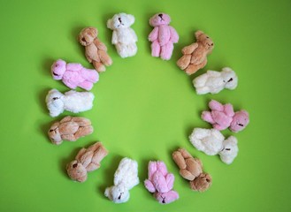 Fototapeta premium frame of teddy bears on green background