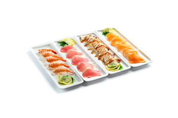 assorted japanese food dishes on rectangular plates on an isolated white background