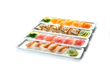 assorted japanese food dishes on rectangular plates on an isolated white background