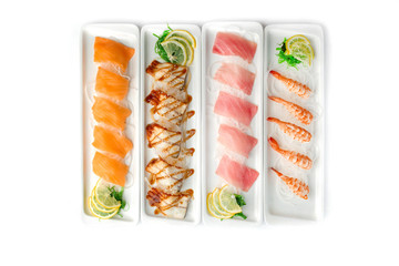 assorted japanese food dishes on rectangular plates on an isolated white background