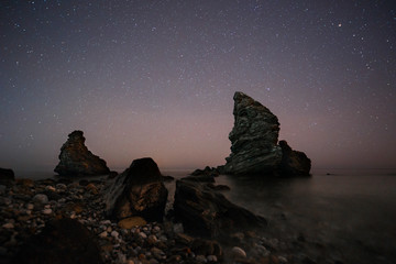 Spain, Malaga, Nerja, Molino de Papel: Starry night on the beach with rocks