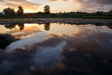 Sunset with clouds reflected on the water of a lake