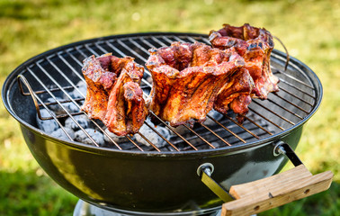 Baby Back Ribs Crown Roast on BBQ barbecue kettle grill.
