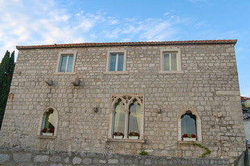 Facade of old house from the end of fifteen century in Venetian gothic style in Bol town, Brac island, Croatia