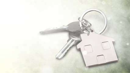 Silver Home key with badge on wooden table