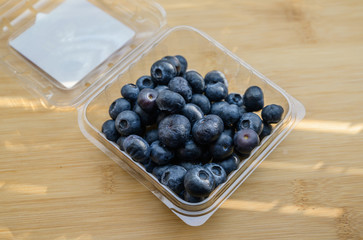 Natural looking blueberries on wooden background. Selective focus.