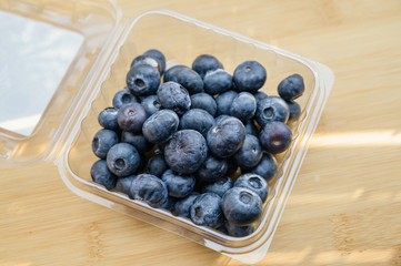 Natural looking blueberries on wooden background. Selective focus.