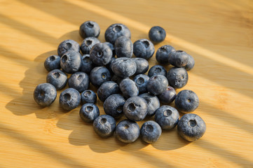 Natural looking blueberries on wooden background. Selective focus.