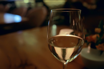 glass of white wine in the restaurant / white wine in the interior of the restaurant a table with glasses of wine, a romantic summer