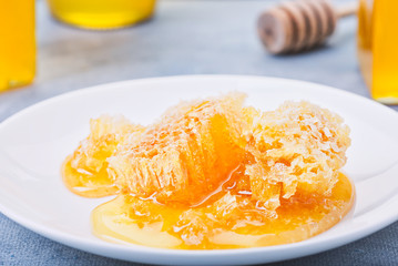 Honey background. Sweet honey in the comb, glass jar.