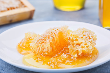 Honey background. Sweet honey in the comb, glass jar.