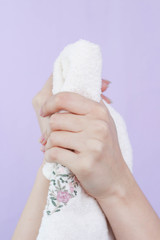 beautiful hands of a girl white towel cream white background
