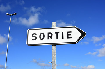 exit sign on blue sky