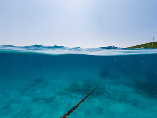 Underwater view of an anchor chain of a ship.