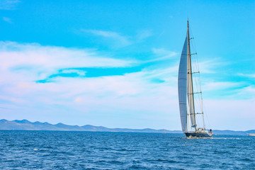 large sailboat in the Adriatic sea on blue and clooud sky background