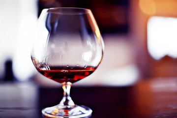 cognac in a glass, a beautiful wide cognac glass, the concept of luxury alcohol