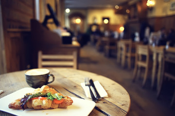 breakfast in a French cafe / croissant with salmon and salad for breakfast in a restaurant