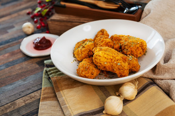 Chicken Wings Spicy chicken wings, breaded, fried, cooked.