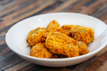 Chicken Wings Spicy chicken wings, breaded, fried, cooked.