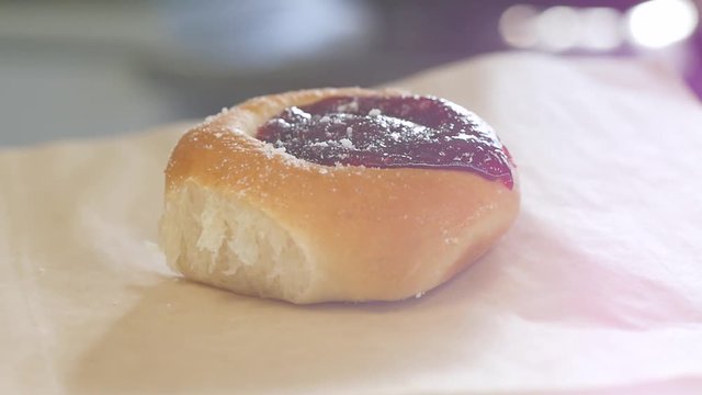 circling around sweet fruit kolache with sunlight leak. Camera circles around delicious-looking fruit kolaches on baking paper.