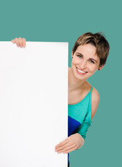 woman billboard. Young beautiful woman showing blank white placard. on background jungle shade green color