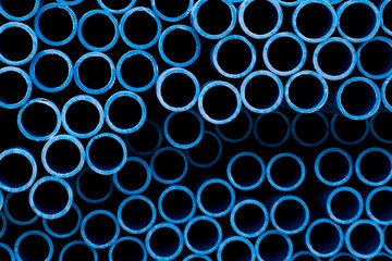 The front image shows the cutting face of the blue PVC pipe. That are arranged on the floor of the construction materials wholesale warehouse. Can be used as a abstract background image.