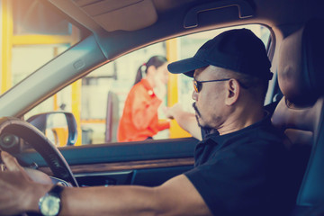 Naklejka premium Selective focus to the man driving the car is paying the expressway