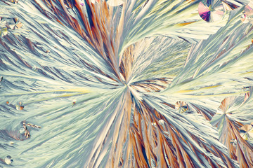 Crystals of food preservative called citric acid, microscope image photographed in cross-polarized...