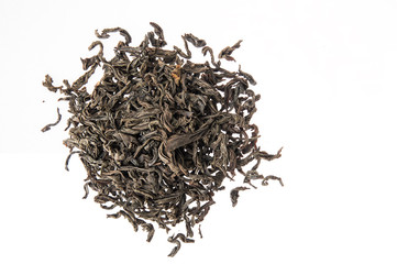Close up. Flat lay, top view. Heap of large leaf dried black tea. Isolated on white background. Copy space.