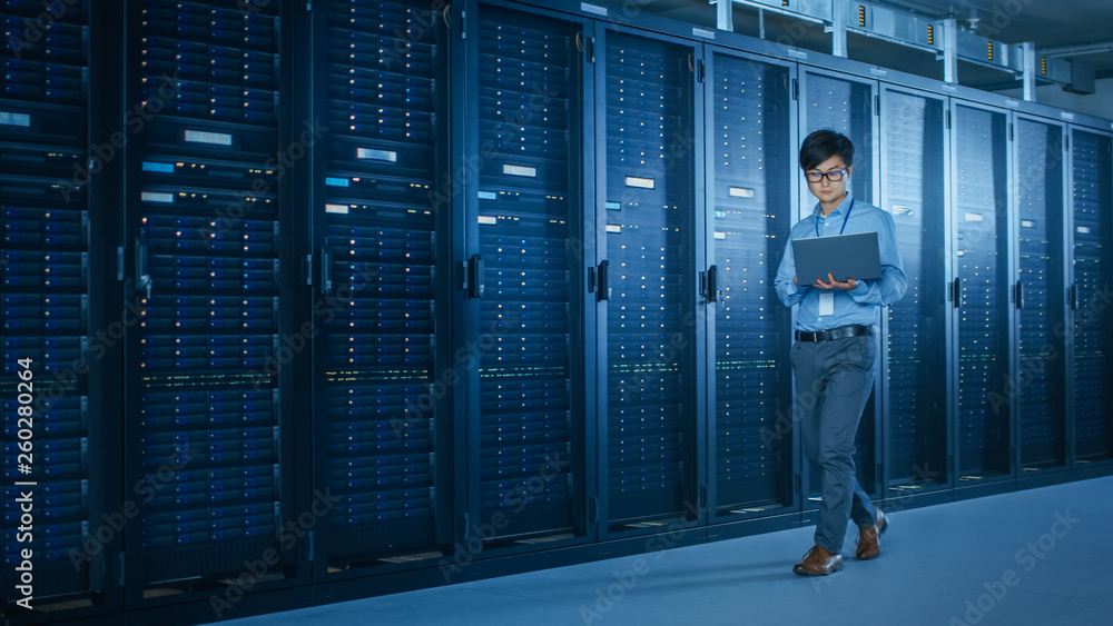 Aufkleber In the Modern Data Center: IT Engineer Working with Server Racks, Uses Laptop for Maintenance and Diagnostics. Checking Stability of the System