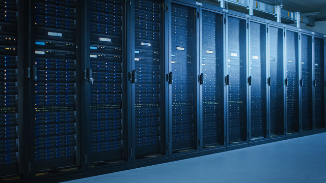 Shot of Modern Data Center With Multiple Rows of Fully Operational Server Racks. Modern High-Tech Telecommunications Database Super Computer in a Room.