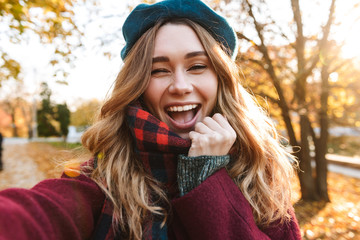 Cheerful young girl with long brown hair wearing autumn