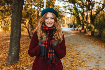 Cheerful young girl with long brown hair wearing autumn