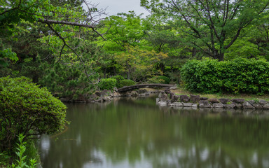 Fototapeta na wymiar Himeji Castle Garden, japanese Garden, with bridge, koys, water and flora, bulb exposure. Himeji, Hyogo, Japan, Asia.