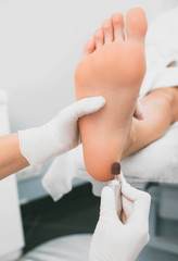 female legs close-up during a hardware manicure