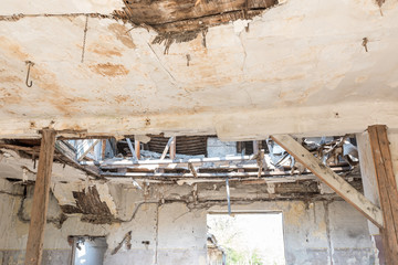 Collapsed rooftop, Broken damaged and collapsed ceiling and roof of old house abandoned after aftermath disaster and heavy rain leakage