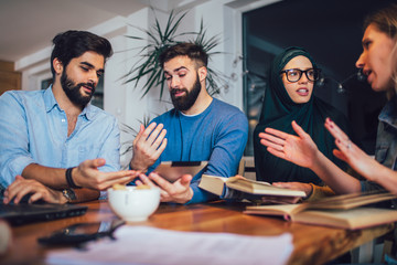 Group of students of diverse ethnic learning at home. Learning and preparing for university exam, selective focus.